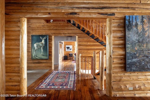 corridor featuring hardwood / wood-style floors and an upstairs landing