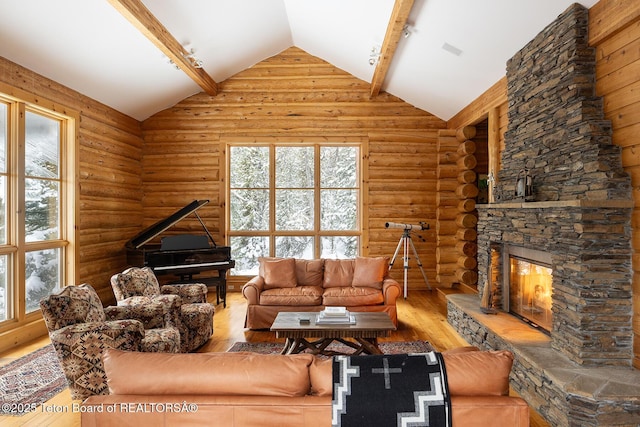 living room with rustic walls, plenty of natural light, wood-type flooring, and beam ceiling