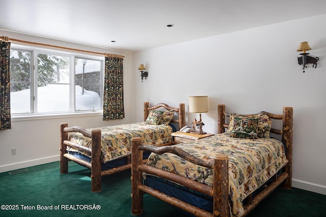 carpeted bedroom featuring baseboards and visible vents