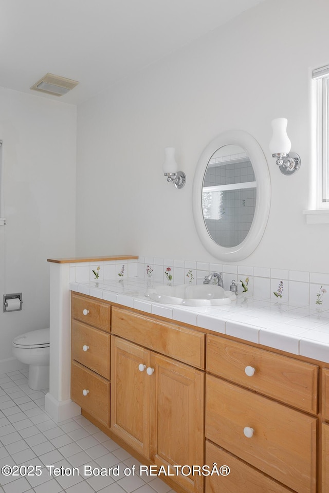 full bathroom with toilet, tile patterned flooring, visible vents, and vanity