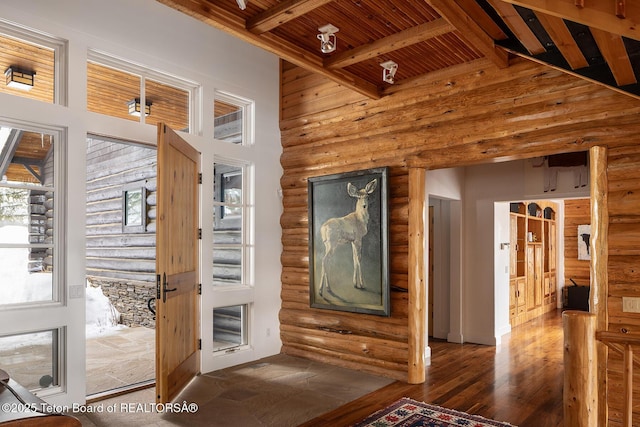 interior space featuring high vaulted ceiling, beam ceiling, hardwood / wood-style flooring, and wood ceiling