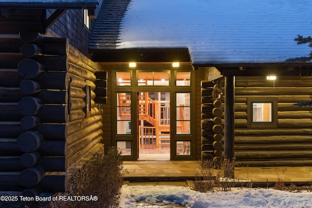 view of exterior entry with log exterior