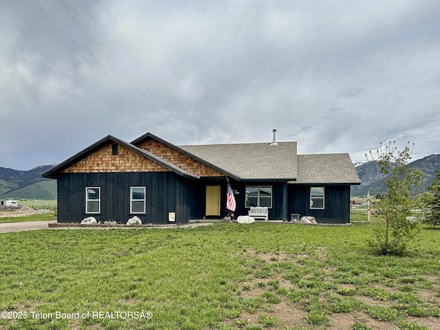 ranch-style home featuring a mountain view and a front yard