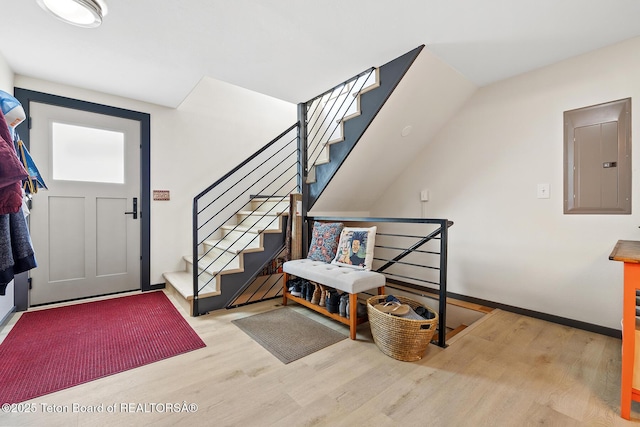 foyer entrance featuring electric panel and light wood-type flooring