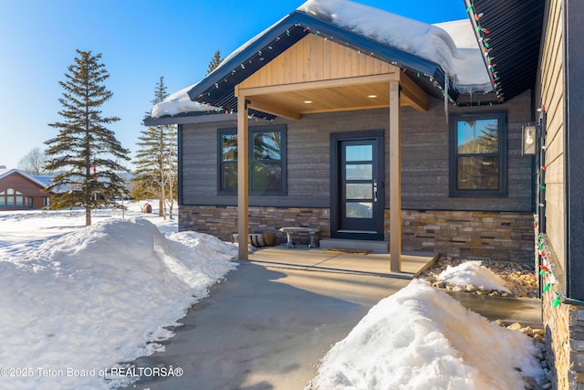 view of snow covered property entrance