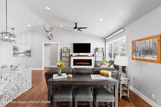 living room with lofted ceiling, ceiling fan with notable chandelier, and dark wood-type flooring