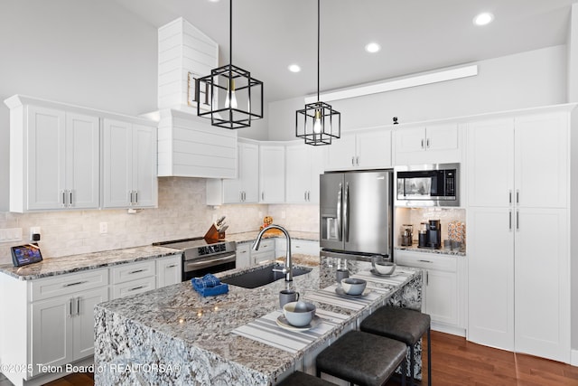 kitchen with white cabinetry, stainless steel appliances, and sink