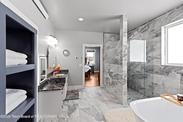bathroom with vanity and separate shower and tub