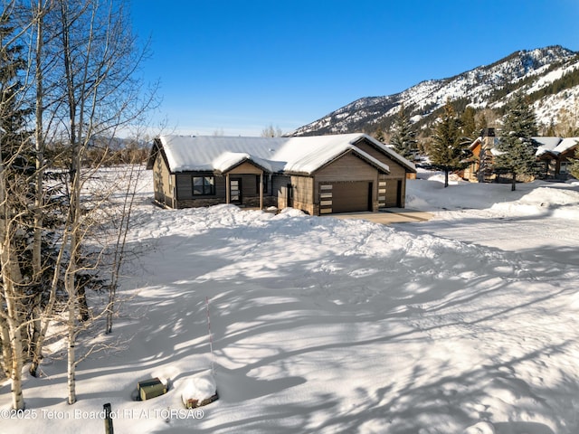 view of front facade with a garage and a mountain view