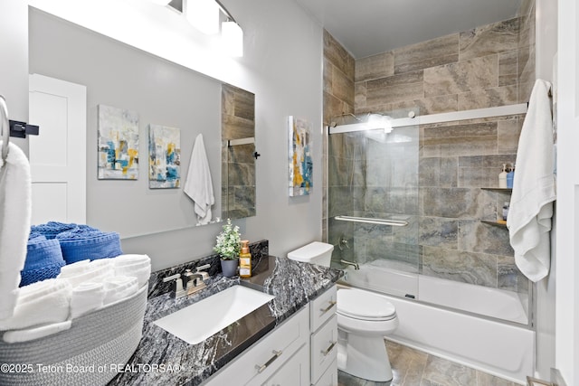 full bathroom with vanity, hardwood / wood-style flooring, enclosed tub / shower combo, and toilet