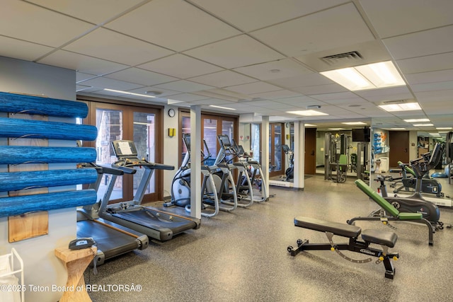 workout area featuring a drop ceiling and french doors