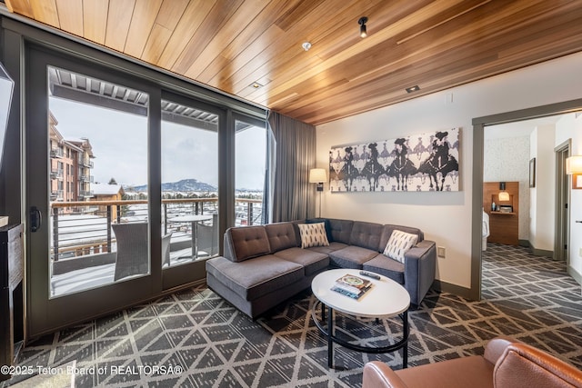 living room featuring wood ceiling, floor to ceiling windows, and a mountain view