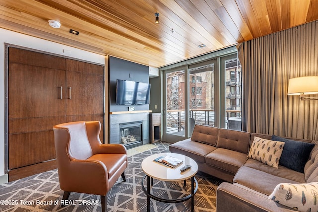 living room featuring floor to ceiling windows, a tile fireplace, and wooden ceiling