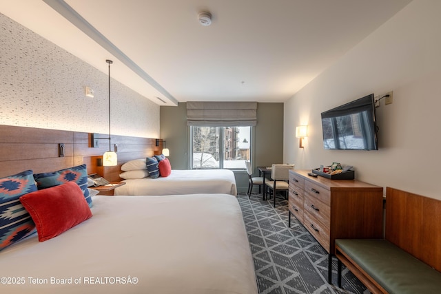 bedroom featuring dark carpet and wood walls