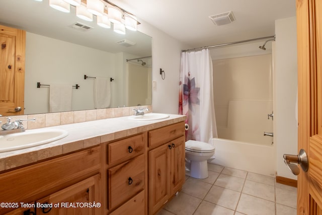 bathroom with a sink, tile patterned flooring, and visible vents