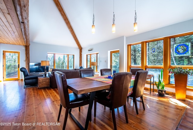 dining room with high vaulted ceiling, beamed ceiling, and hardwood / wood-style flooring