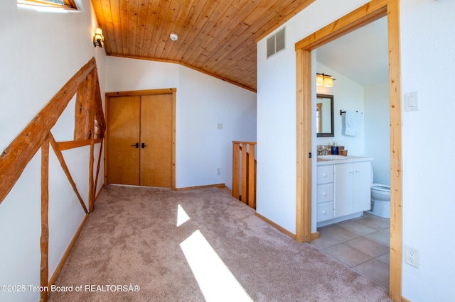 corridor with carpet, wood ceiling, vaulted ceiling, and a sink