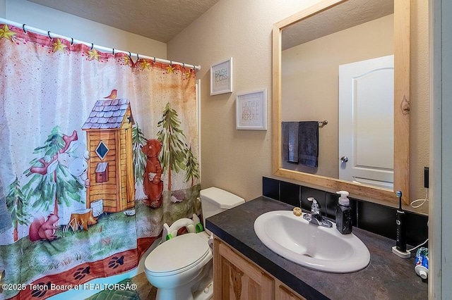 420 Roberts St, Thayne, WY 83127 - bathroom with toilet, vanity, and a textured ceiling