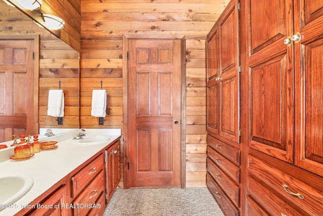 bathroom with vanity and wood walls