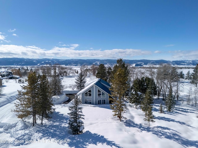 snowy aerial view with a mountain view