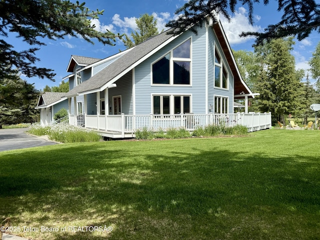 388 Middle Branch Dr, Star Valley Ranch, WY 83127 - view of side of home with a shingled roof, a lawn, and a deck