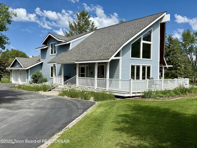 388 Middle Branch Dr, Star Valley Ranch, WY 83127 - view of front facade featuring roof with shingles, a front yard, and driveway