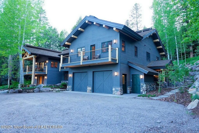 view of front facade with a balcony and a garage