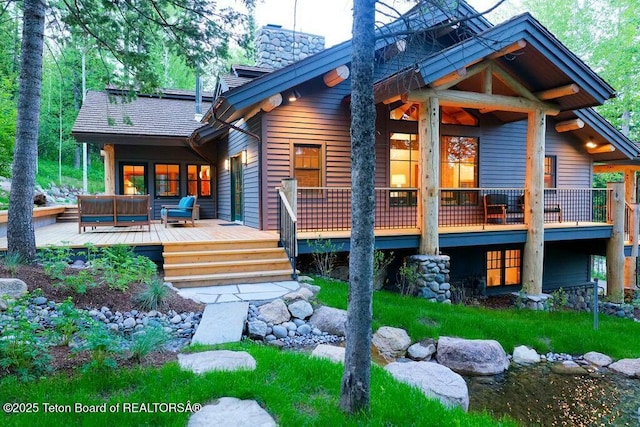 rear view of house with an outdoor hangout area and a deck