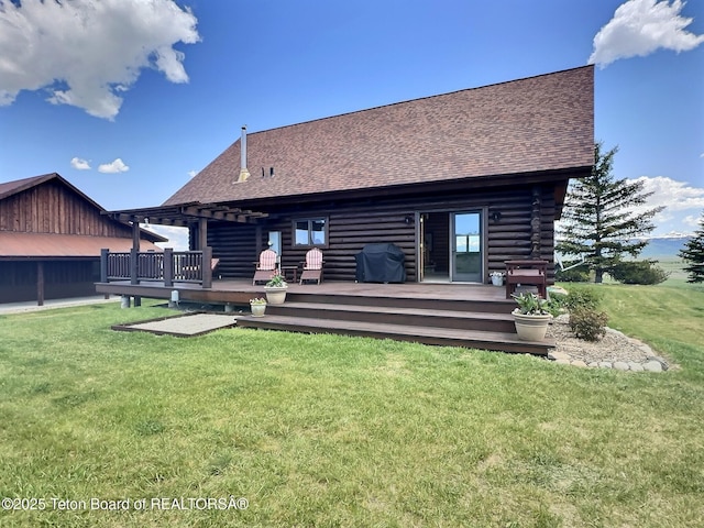 6352 W 1170 N, Driggs, ID 83442 - back of house with log exterior, a shingled roof, a wooden deck, and a yard