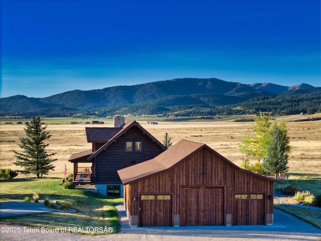 6352 W 1170 N, Driggs, ID 83442 - view of front of home featuring a mountain view, a chimney, a garage, a rural view, and roof with shingles