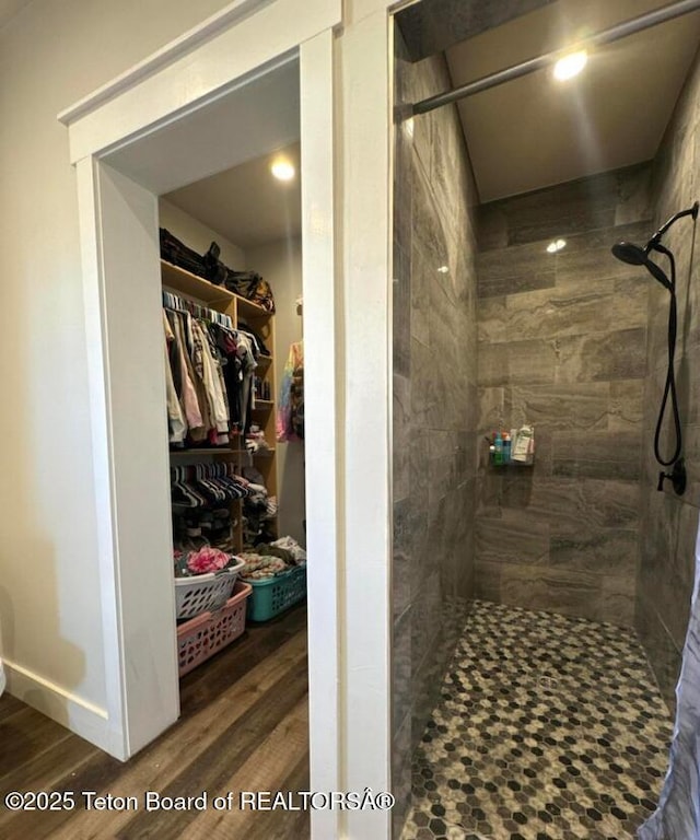 bathroom featuring tiled shower and hardwood / wood-style floors