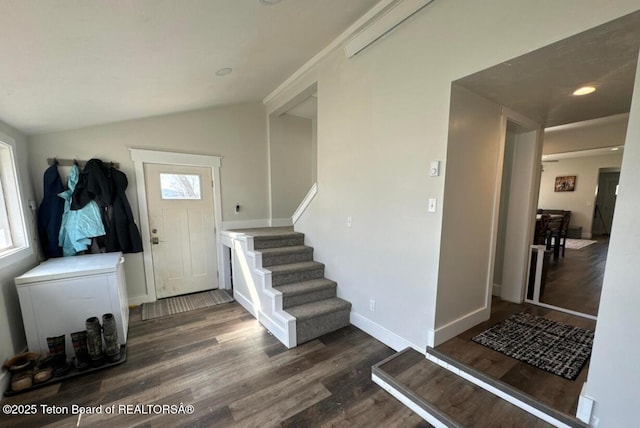 entryway with lofted ceiling and dark wood-type flooring