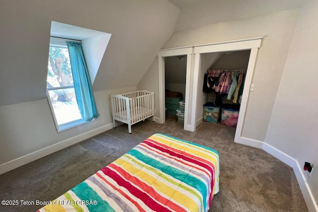 bedroom featuring lofted ceiling, a closet, and dark colored carpet