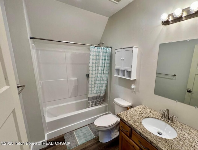 full bathroom with lofted ceiling, hardwood / wood-style floors, vanity, toilet, and shower / bath combo with shower curtain