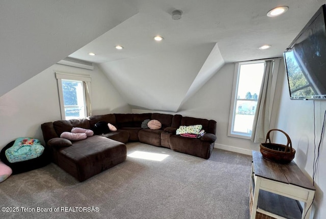 carpeted living room with lofted ceiling