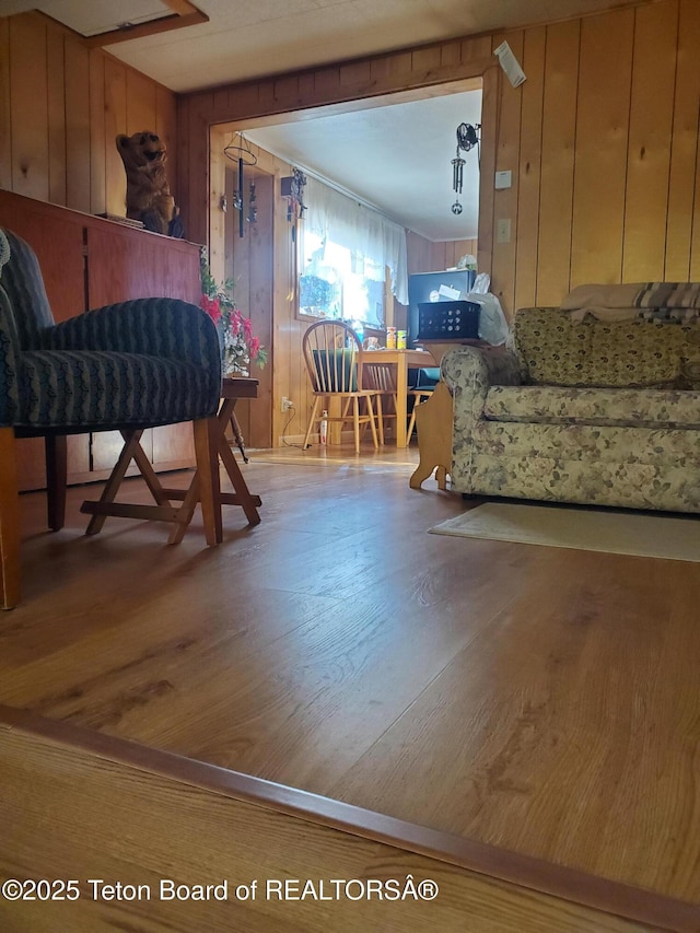 dining area with wooden walls and light hardwood / wood-style floors