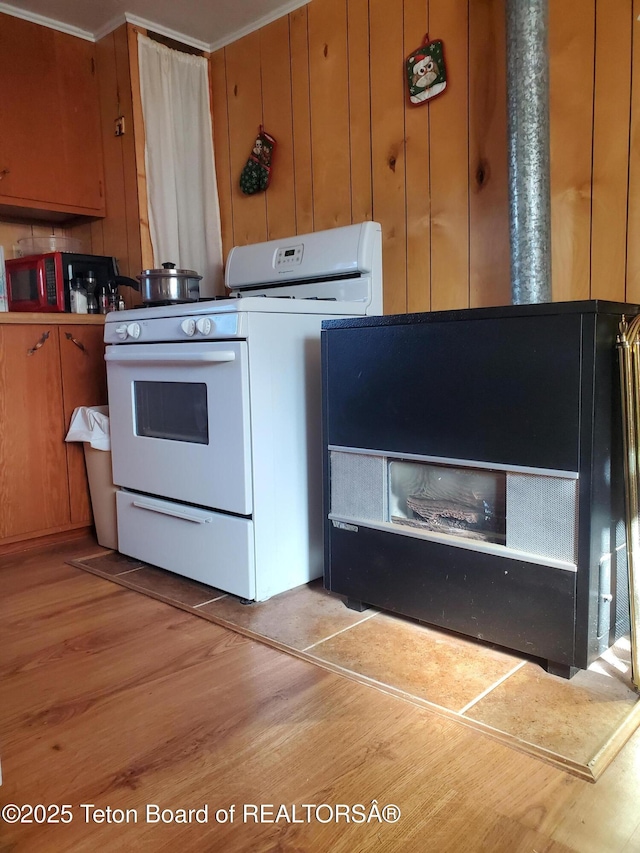 laundry area featuring wood walls and light wood-type flooring