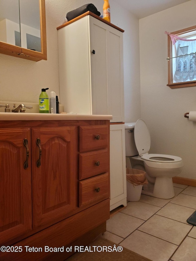 bathroom featuring vanity, tile patterned floors, and toilet