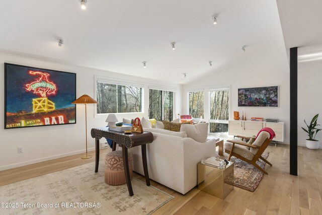725 Cache Creek Dr, Jackson, WY 83001 - living room with light hardwood / wood-style flooring and vaulted ceiling