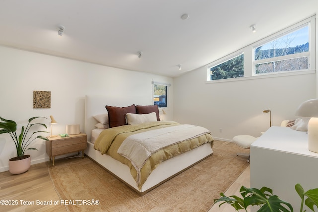 725 Cache Creek Dr, Jackson, WY 83001 - bedroom with lofted ceiling and light hardwood / wood-style flooring