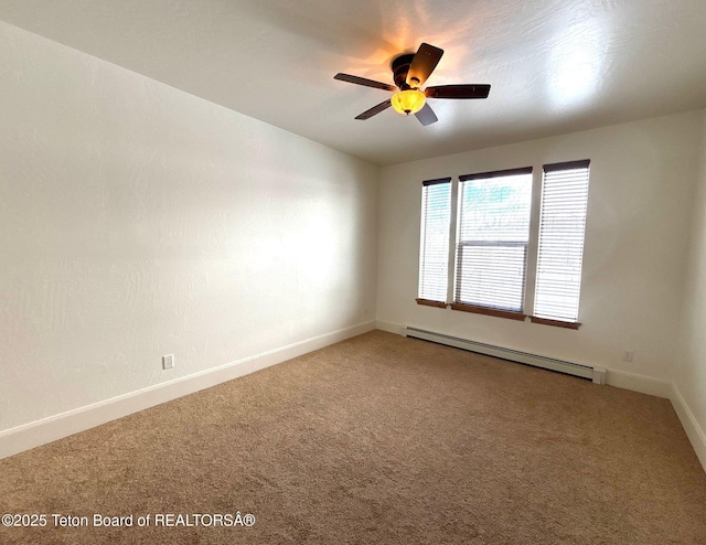 spare room with a baseboard heating unit, baseboards, carpet floors, and ceiling fan