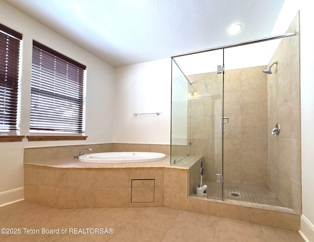 full bathroom with tile patterned floors, a bath, and a stall shower