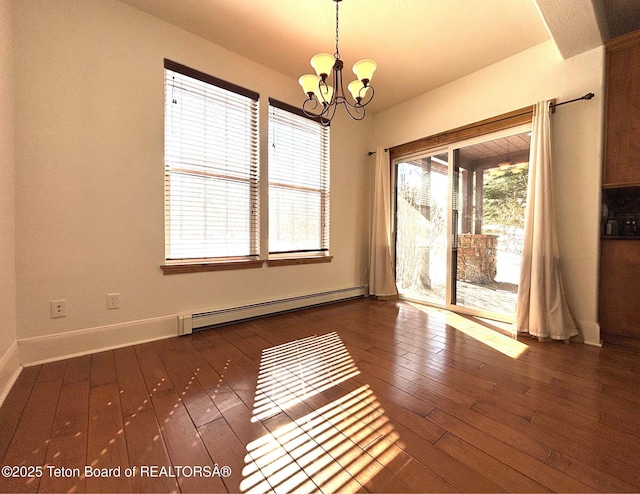 unfurnished room with baseboards, wood-type flooring, an inviting chandelier, and a baseboard radiator