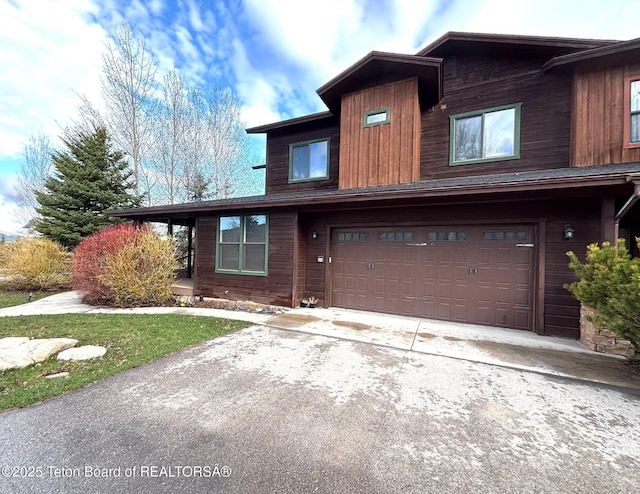 view of front of property with concrete driveway and a garage