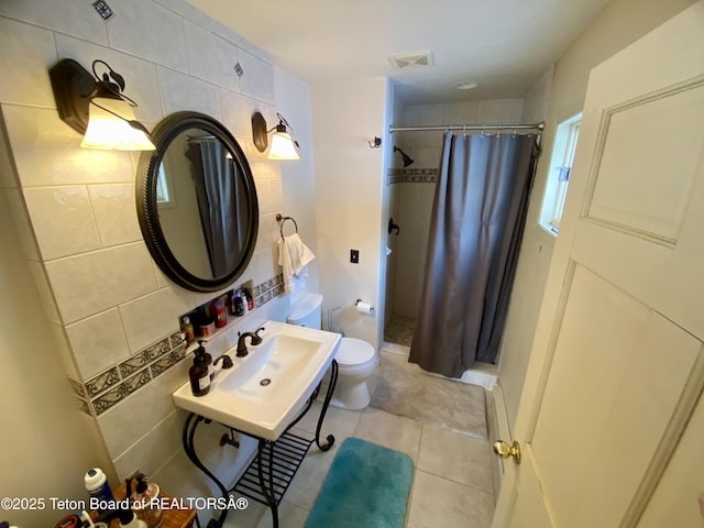 full bathroom with toilet, a shower stall, visible vents, and tile patterned floors