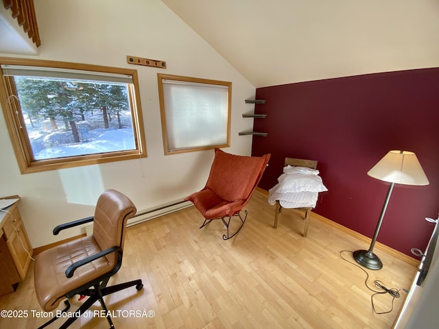 office area with lofted ceiling, light wood-style flooring, baseboards, and baseboard heating