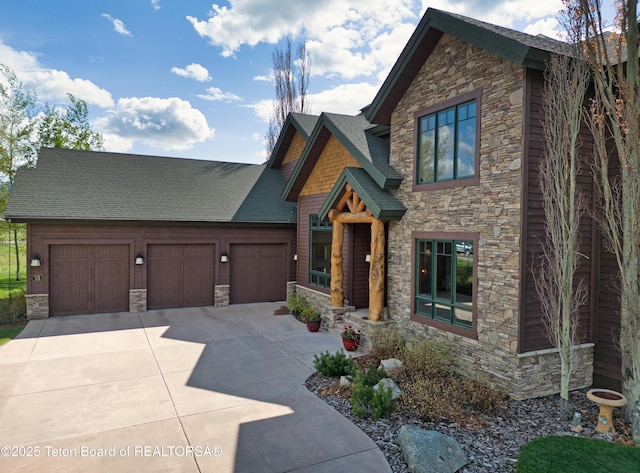 15 Kearsley Ln, Victor, ID 83455 - craftsman inspired home with stone siding, an attached garage, driveway, and a shingled roof