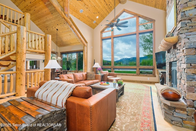 15 Kearsley Ln, Victor, ID 83455 - living area with a ceiling fan, high vaulted ceiling, a fireplace, a wood ceiling with exposed beams, and wood finished floors