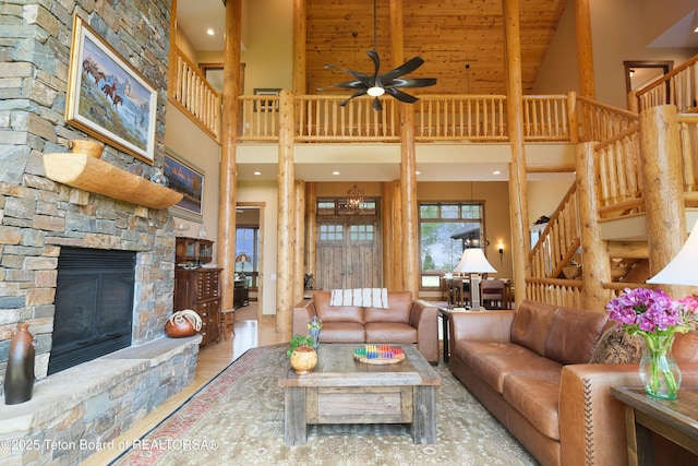 15 Kearsley Ln, Victor, ID 83455 - living area with high vaulted ceiling, stairway, a fireplace, a ceiling fan, and beamed ceiling
