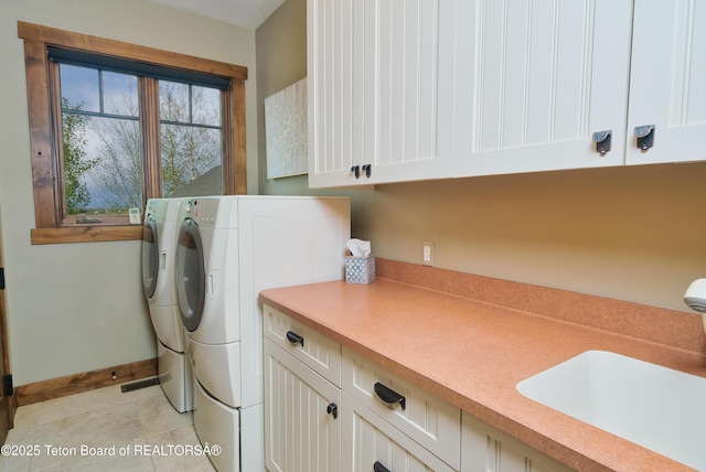 15 Kearsley Ln, Victor, ID 83455 - laundry room with washer and dryer, cabinet space, and light tile patterned floors